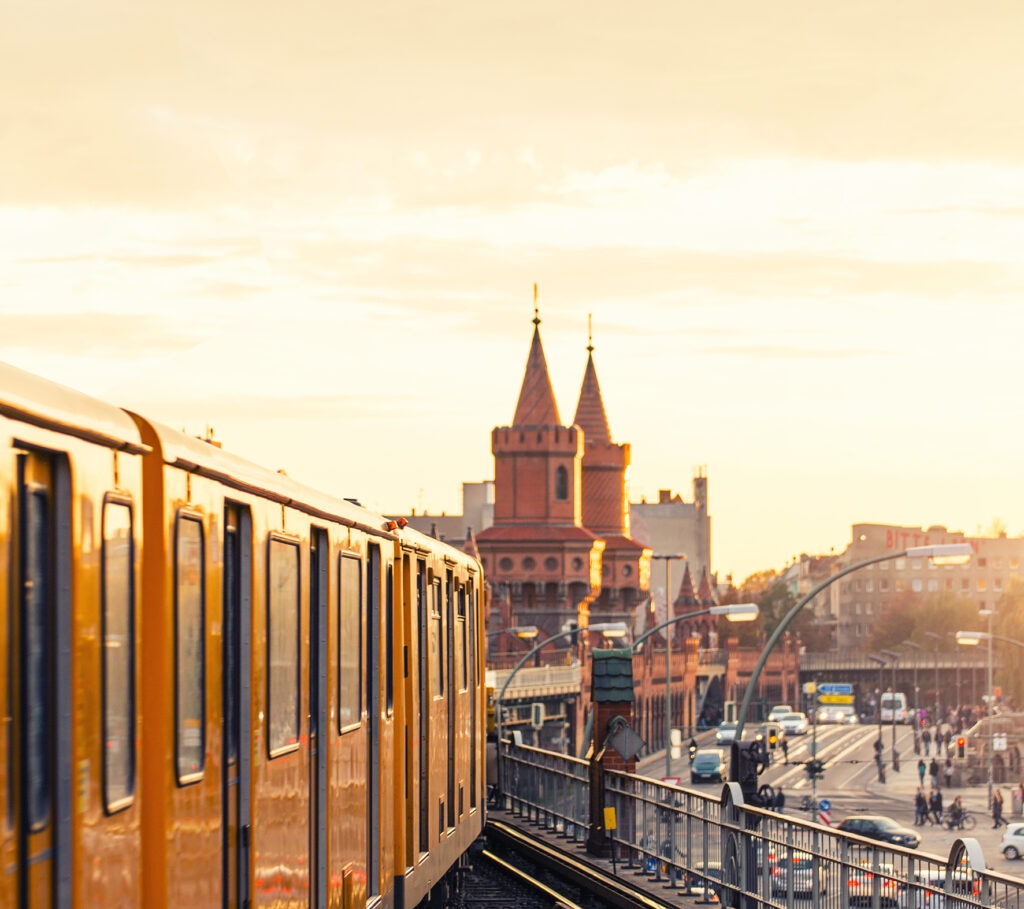 Yellow subway train in front of Oberbaumbrücke in Berlin in the evening light