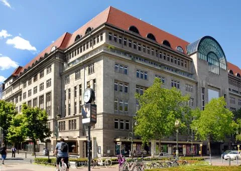Historical department store building with glass windows and bicycles on the street, Berlin