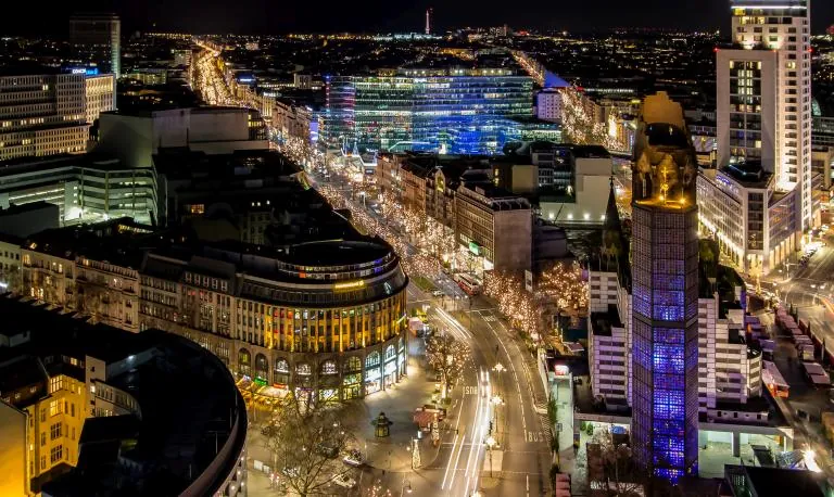Aerial view of the illuminated cityscape with memorial church tower at night, Berlin