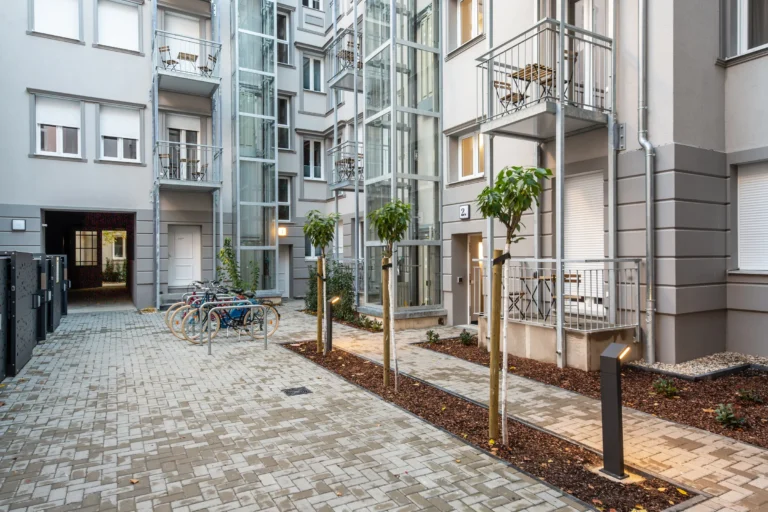 Greened courtyard with paving, bike racks and balconies, ipartment Berlin Mitte