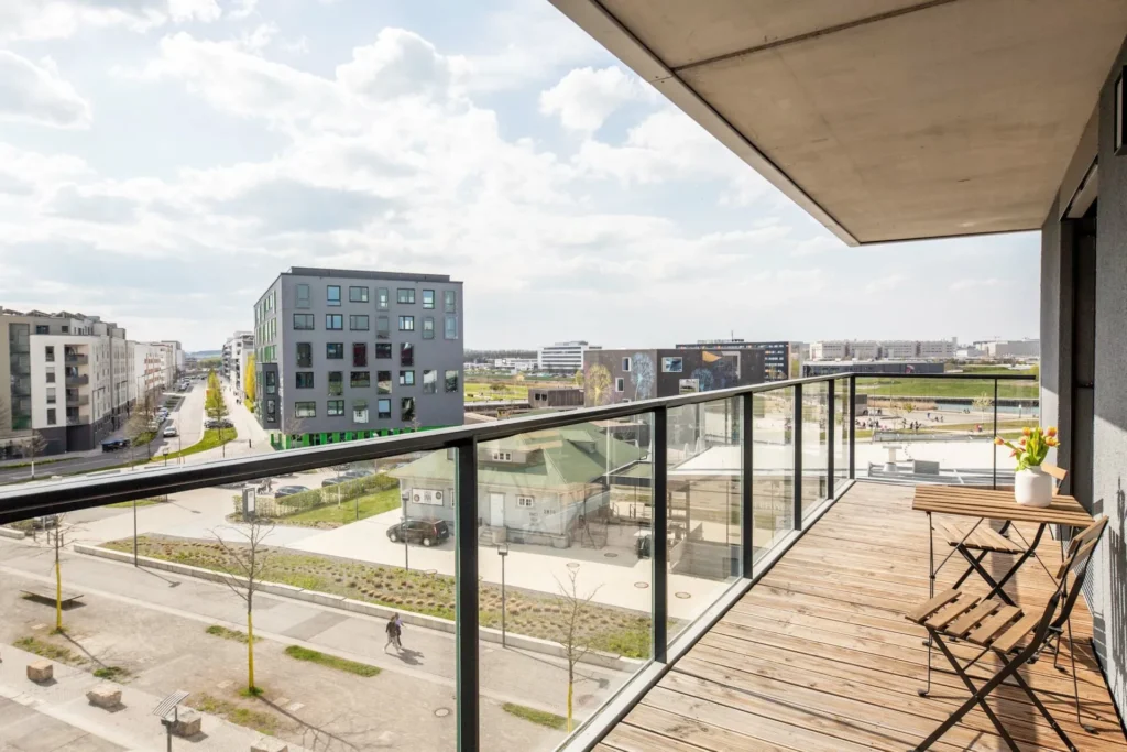 Balcony with wooden floor and folding chairs, view of the airfield area in the Medium apartment, ipartment Böblingen-Sindelfingen
