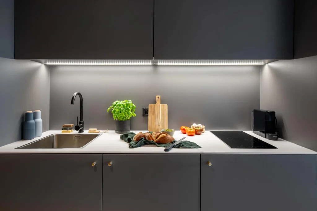 Designer kitchen with sink, induction stove, coffee machine and cutting board in Apartment M, ipartment Braunschweig