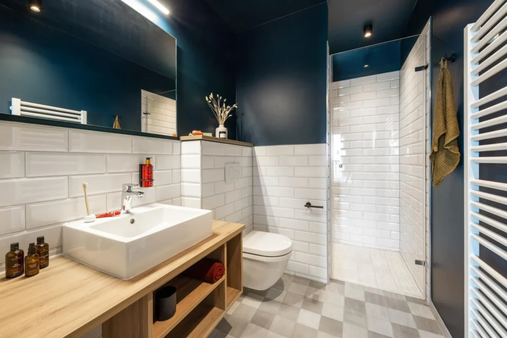 Bathroom with built-in sink, wooden washbasin, metro tiles and shower in apartment M, apartment Braunschweig