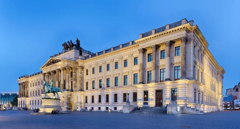 Illuminated residence castle with quadriga and equestrian statue in the dusk, Braunschweig
