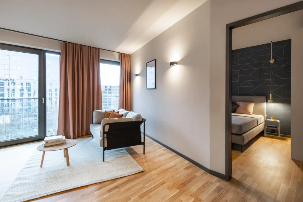 Living room with sofa and view through the door into the bedroom in the Luxury apartment, Darmstadt
