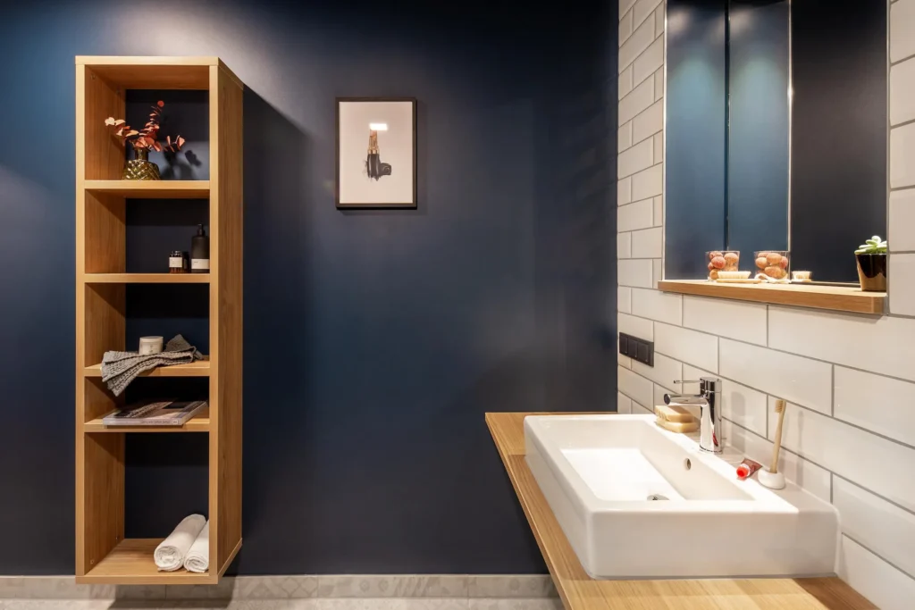 Bathroom with sink, wooden shelf and dark blue wall in the Luxury apartment, ipartment Darmstadt