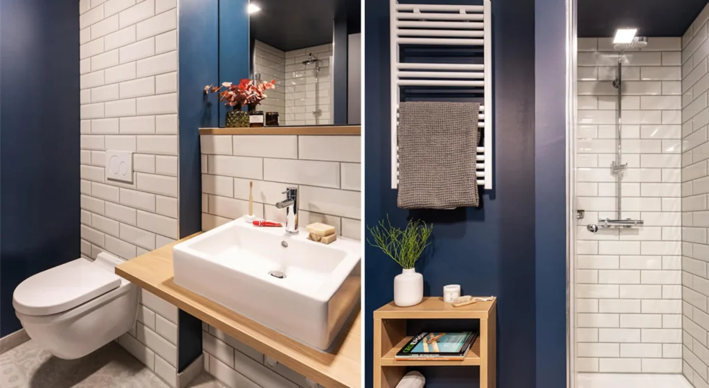 Bathroom with sink, shower and towel heater in front of dark blue wall in the Smart apartment, ipartment Darmstadt