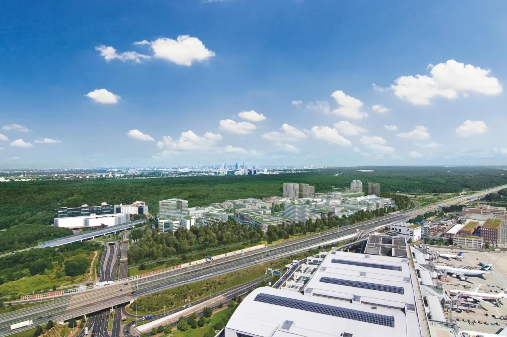 Aerial view of Gateway Gardens with highway, airport terminal and Frankfurt skyline in the background