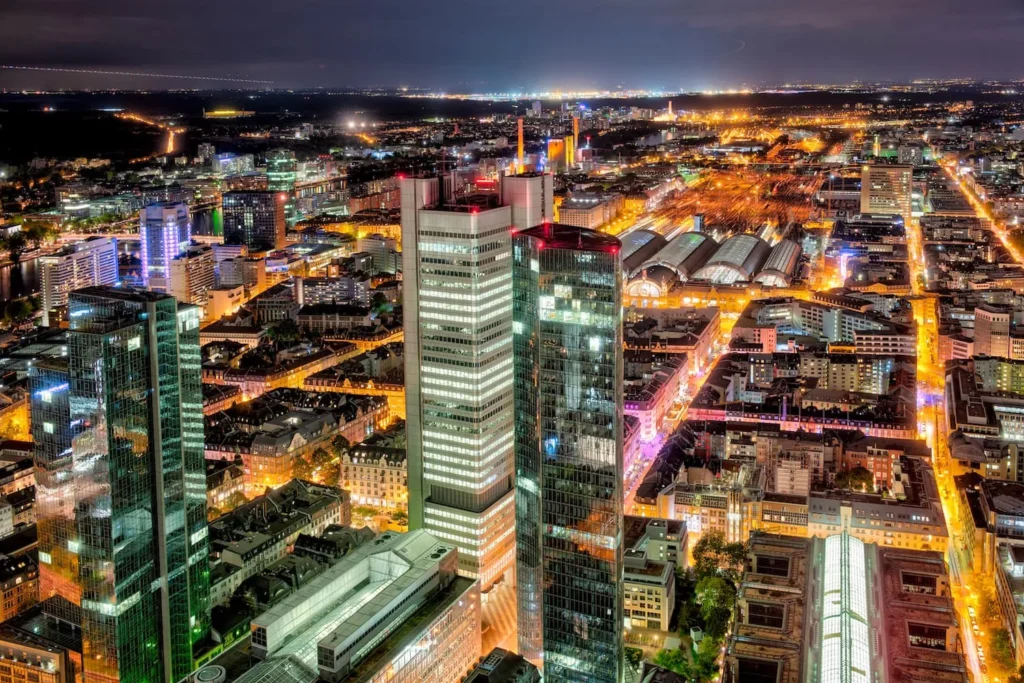 Night view of illuminated high-rise buildings and the train station halls in the Frankfurt train station district, Frankfurt am Main