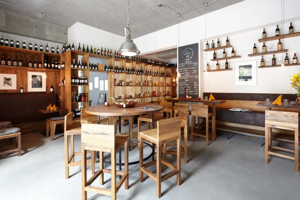 Wine racks, high wooden tables and bar stools in the restaurant daVinc Cucina e Vino in the European Quarter, Frankfurt