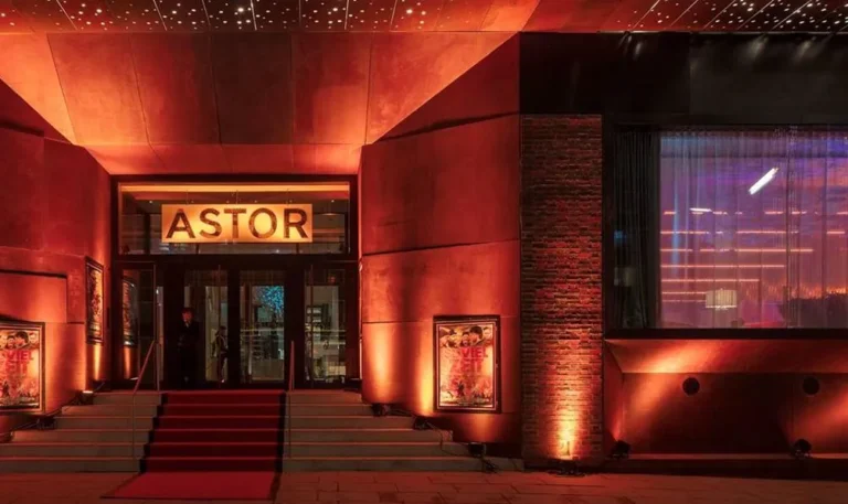 Illuminated entrance of the Astor Film Lounge HafenCity with red carpet and illuminated lettering