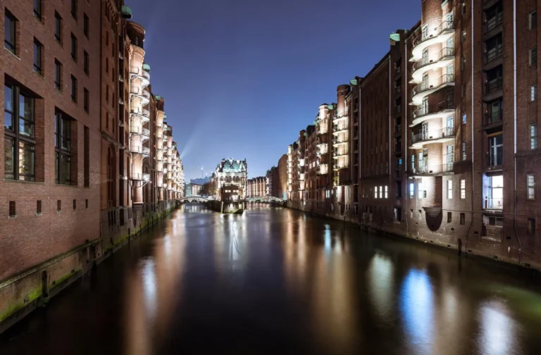 Illuminated brick warehouses in the Hamburger Speicherstadt at Fleet at dusk