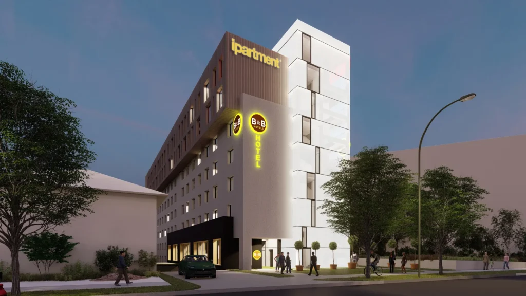 Visualisierung des geplanten Apartmenthauses in Stuttgart in der Abenddämmerung mit ipartment- und B&B-Hotel-Schriftzug an der Fassade