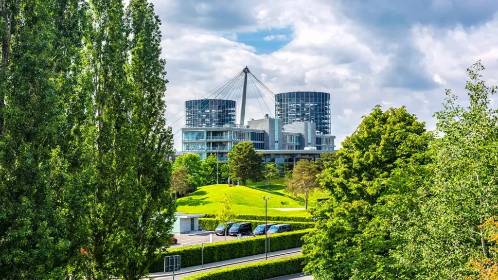 Buildings of the Autostadt between trees and green spaces in Wolfsburg
